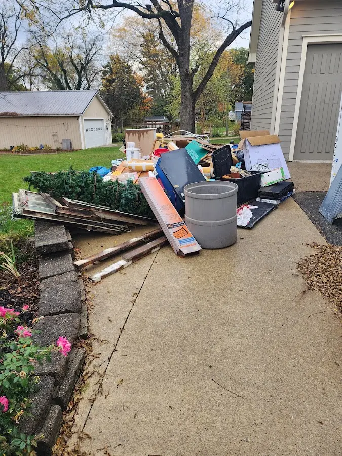 Dumpster being loaded with debris for 12 Yard Dumpster Rental in Hilliard